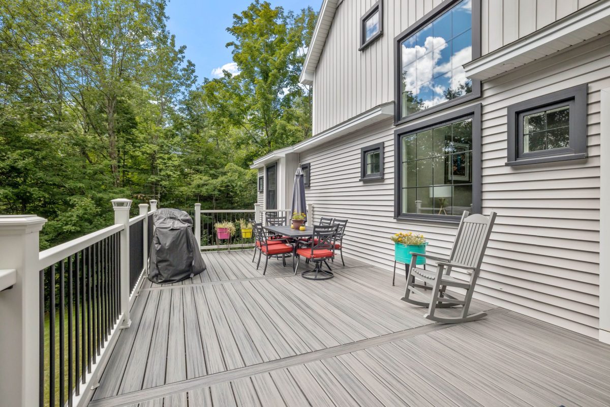 modern-custom-new-england-colonial-home-with-american-flag-sunny-day-min